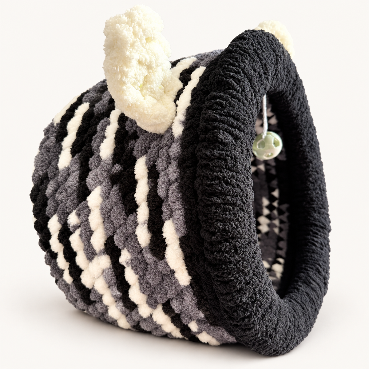 Chunky Knit Cave black, grey and white, left side view on warm white background