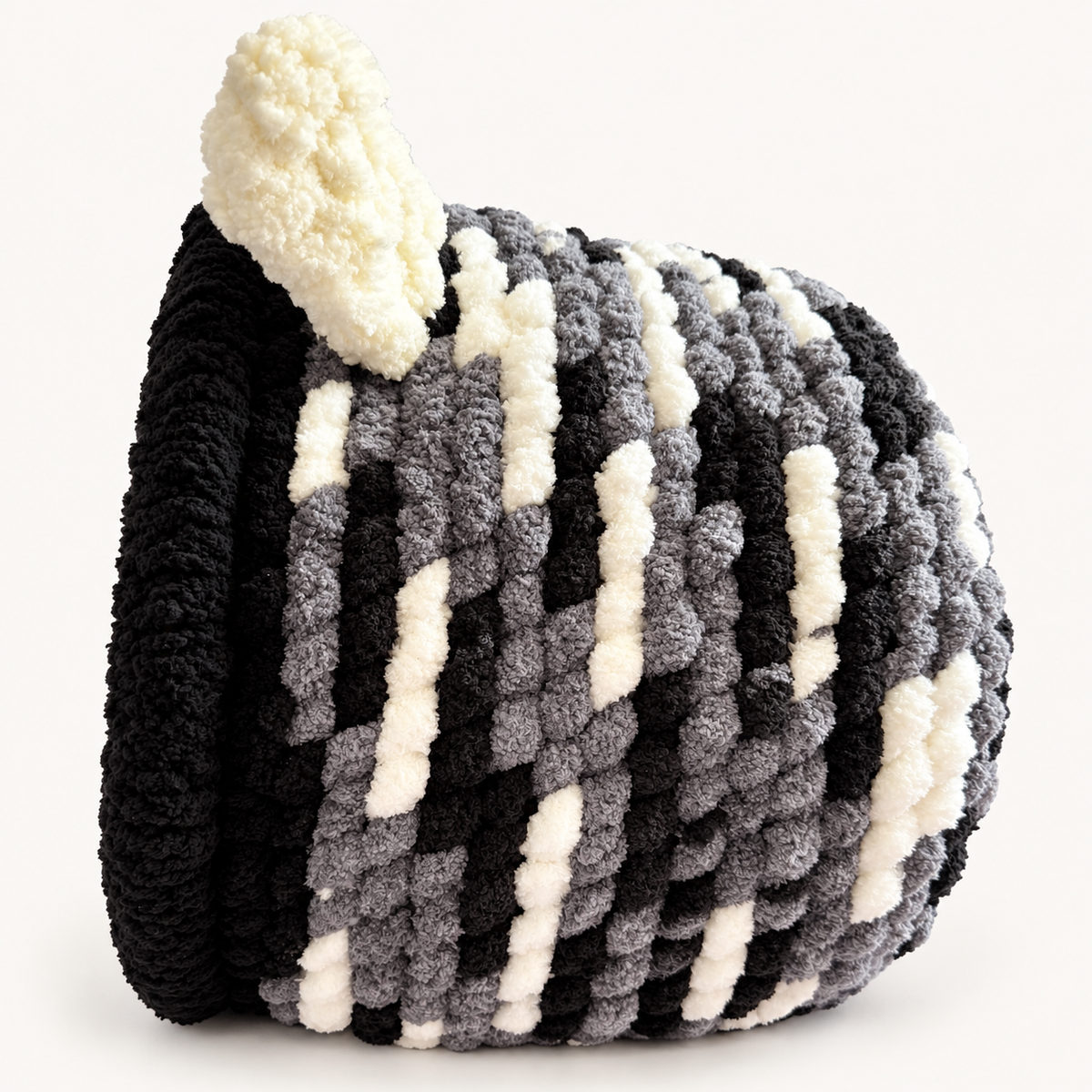 Chunky Knit Cave black, grey and white, right side view on warm white background